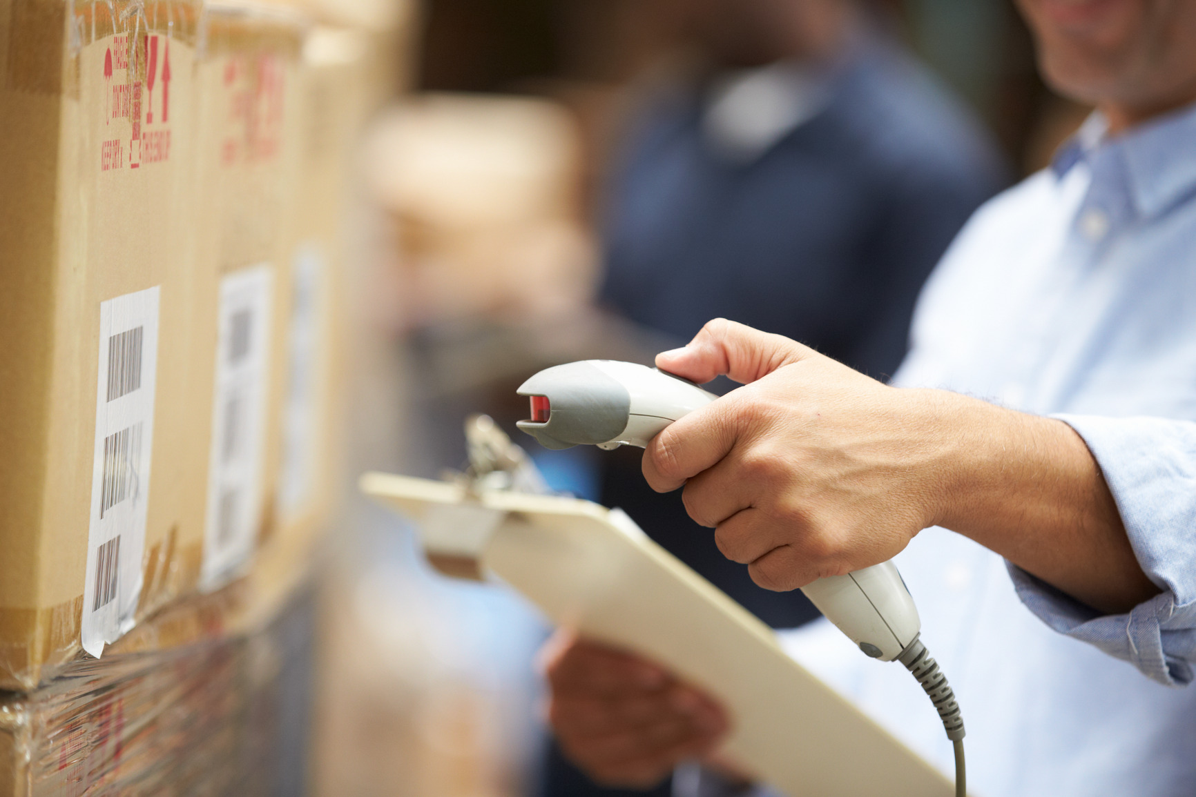 Worker Scanning Package In Warehouse - Integrated Packaging Company